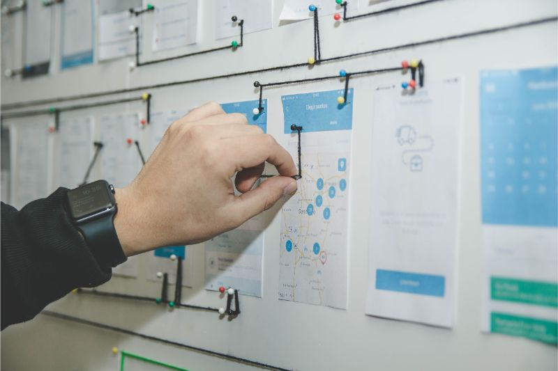 Printed wireframes pinned to a wall